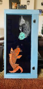 Koi fish-skeleton pianted on recycled glass window